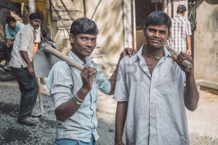 ai-india--08-january-2015-two-young-indian-workers-stand-in-street-with-hoe-s-in-hands-young-boy.jpg