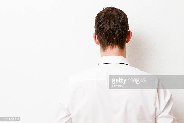 back-of-businessman-against-a-wall-picture-id175426663?s=612x612.jpg