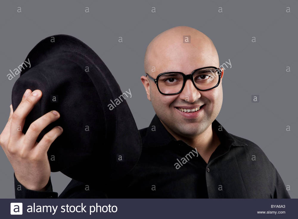 bald-man-taking-off-his-hat-BYA6A3.jpg