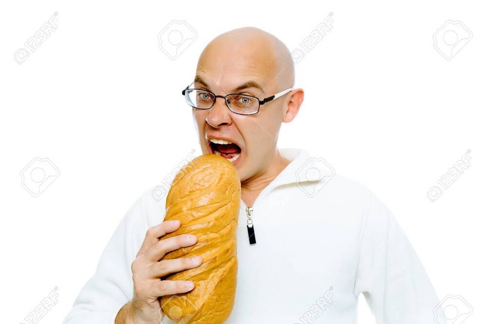 -with-glasses-bites-a-a-large-loaf-studio-isolated.jpg