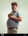 nothing-better-than-beer-after-a-long-day-an-overweight-man-looking-content-while-balancing-hi...jpg